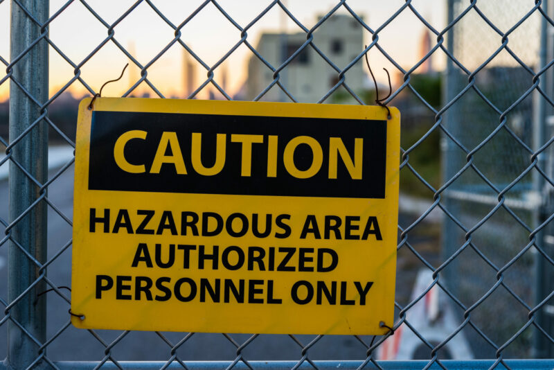 Caution,Sign,For,Hazardous,Area,On,Metal,Fence